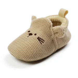 Soft knitted baby walking shoe featuring a cute embroidered cartoon cat face design.