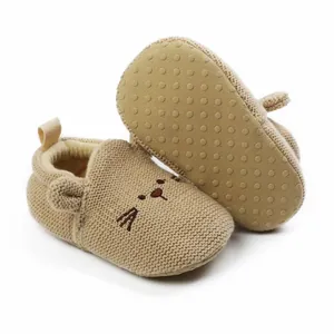 Macro view of baby knit shoes with soft non-slip sole and cute cartoon cat embroidery
