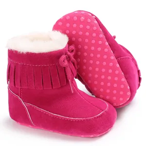 Detailed view of magenta baby snow boots with fringes and thick warm white fleece lining
