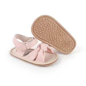 Detailed view of pink baby walker sandals with anti-slip sole and soft bow decoration