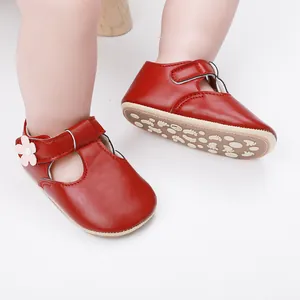 Close-up of red baby girl princess shoes with floral detail and anti-slip rubber sole