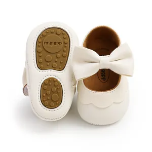 White PU leather baby princess shoes with a large bow and non-slip soft sole detail