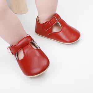 Close-up detail of red baby girl princess shoes with soft rubber soles and flower accent
