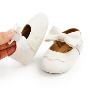 Macro detail shot of cream PU leather baby princess shoes with large bow and velcro strap