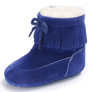Detailed view of blue suede baby winter boots with fringe and soft fur lining