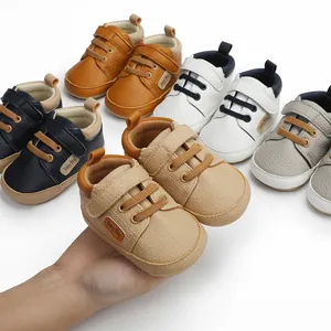 Detailed macro view of colorful soft-sole baby walker shoes featuring Baby Boy tags