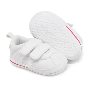 Detail shot of white baby pre-walker sneakers showcasing anti-slip dotted rubber sole