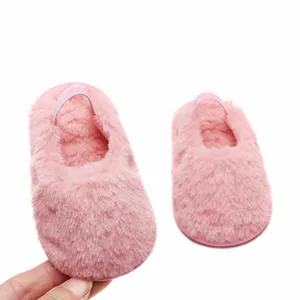 Primo piano di pantofole rosa pelose per neonati con cinturino elastico 0-1 anno