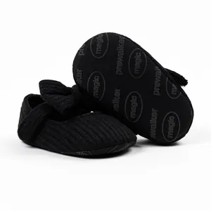 Detailed macro view of black knit baby pre-walker shoe sole with anti-slip pattern
