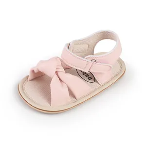 Pink baby sandals for 0-1 year olds featuring soft bow design and velcro strap