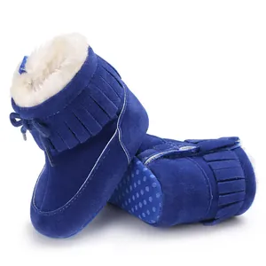 Detailed view of blue baby snow boots with warm faux fur lining and fringe.