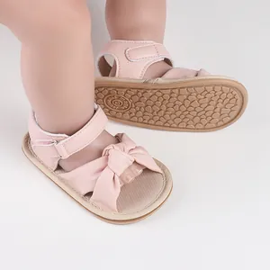 Pink baby girl prewalker sandals with cute bow and non-slip rubber sole detail.