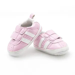 Soft pink baby pre-walker shoes with white anti-slip rubber soles and sporty stripes