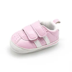 Detailed side view of pink baby pre-walker shoe with non-slip sole and velcro straps