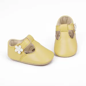 Soft yellow baby girl princess shoes featuring a delicate white flower and secure T-strap