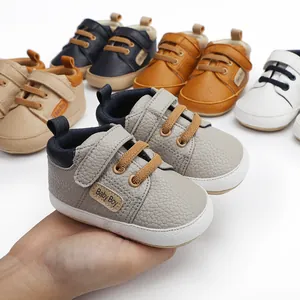 Detailed view of grey soft-sole baby boy walker shoes with multiple colors in background