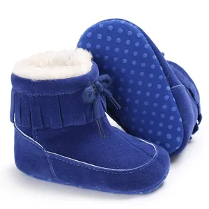 Detail of blue baby snow boots featuring fringe tassels and plush faux fur lining