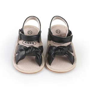 Black baby walking sandals with decorative bow for 0-1 year old infants close-up