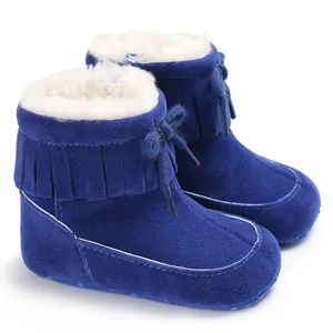 Detail view of blue baby winter snow boots with soft fleece lining and tassel trim.