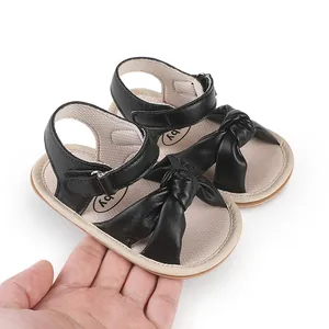 Detail of black infant walker sandals with bow and soft sole for 0-1 year olds