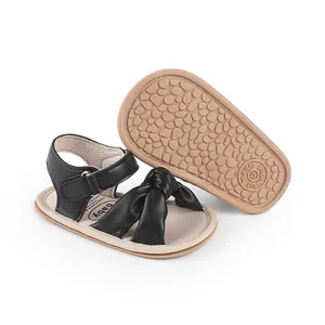 Soft black baby prewalker sandals with decorative knot and non-slip textured rubber sole