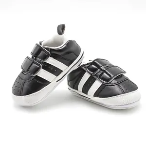 Detail of black and white baby sports shoes with non-slip rubber sole