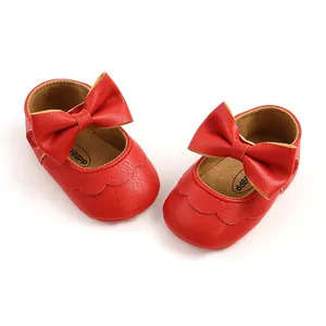 Detailed view of red PU leather baby princess shoes with a large decorative bow