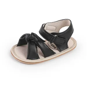Detailed view of black baby pre-walker sandal featuring a stylish large knot bow design