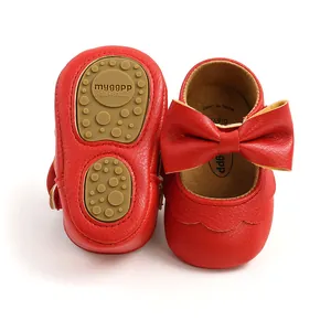 Detailed view of red bow baby shoes with non-slip soft rubber soles