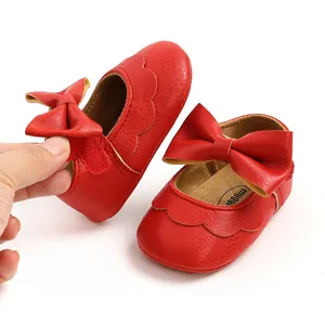 Close-up of red PU baby princess shoes featuring hook and loop bow strap
