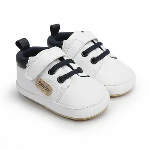 Detail view of premium white leather baby boy walker shoes with navy blue laces
