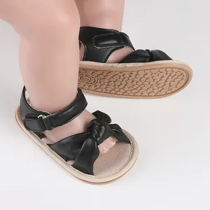 Close-up of black baby walker sandals with bow detail and non-slip sole for 0-1 year olds