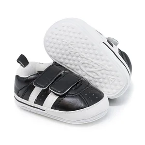 Close-up of black baby walking shoes with non-slip rubber sole and velcro straps