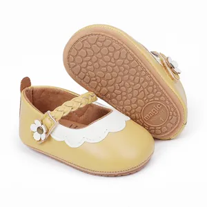 Nahaufnahme gelber Baby-Lauflernschuhe mit geflochtenem Riemen und rutschfester Sohle
