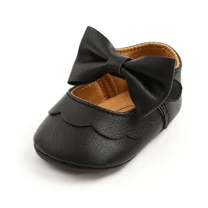 Detailed view of black PU leather baby princess shoes featuring a large decorative bow.