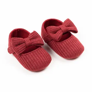 Red ribbed baby walking shoes for girls with decorative bow-knot detail
