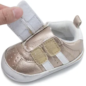 Detail showing hook and loop strap closure on metallic gold infant walking shoes
