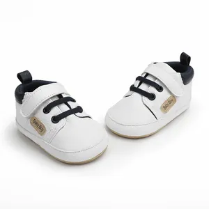 Detail view of these white infant walking shoes with navy laces for 0-1 year olds