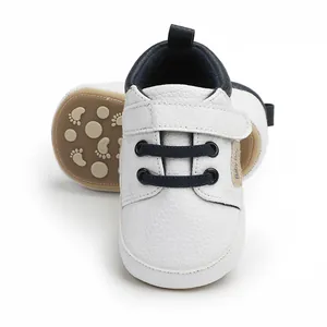 Detailed view of white infant walking shoes with soft soles for babies aged 0-12 months