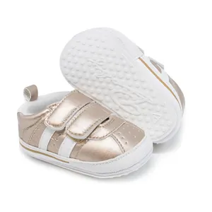 Detail view of metallic gold baby walking shoes with non-slip rubber sole design