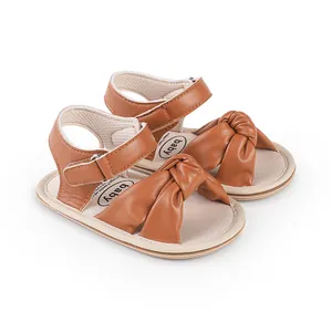 Detail view of infant baby walking shoes with brown knot design for 0-1 year olds