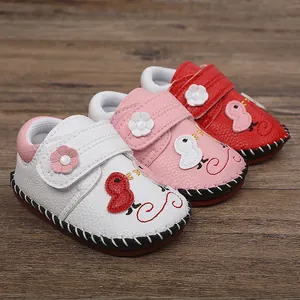Detalle de zapatos de bebé con dibujos animados y suelas de goma antideslizantes