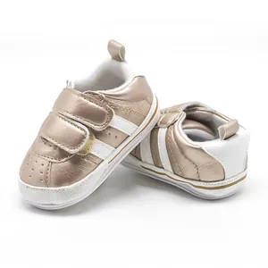 Close-up of champagne gold baby walking shoes with non-slip white rubber sole