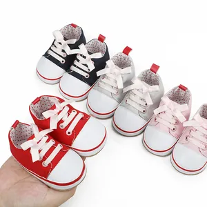 Detailed view of colorful soft-sole baby girl walker shoes with cute bow tie accents