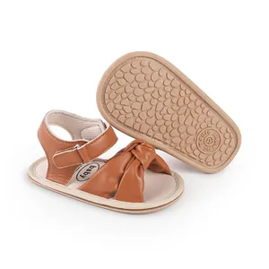 Detailed view of brown baby bow sandals with non-slip soft sole for pre-walkers