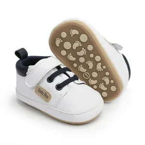 Close-up detail of white faux leather baby boy walking shoes featuring anti-slip rubber soles