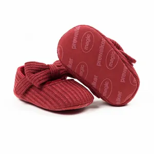 Detailed view of red knitted baby prewalker shoes with non-slip sole pattern.
