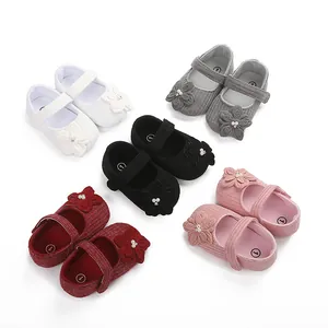 Dettaglio di scarpine per neonati in cinque colori con decorazioni a fiori e perle.