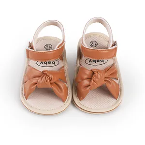 Top view showing the bow design and soft fabric insole of brown baby pre-walker sandals.
