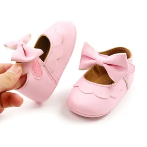 Close-up of pink baby princess shoes featuring soft PU leather and velcro bow closure.